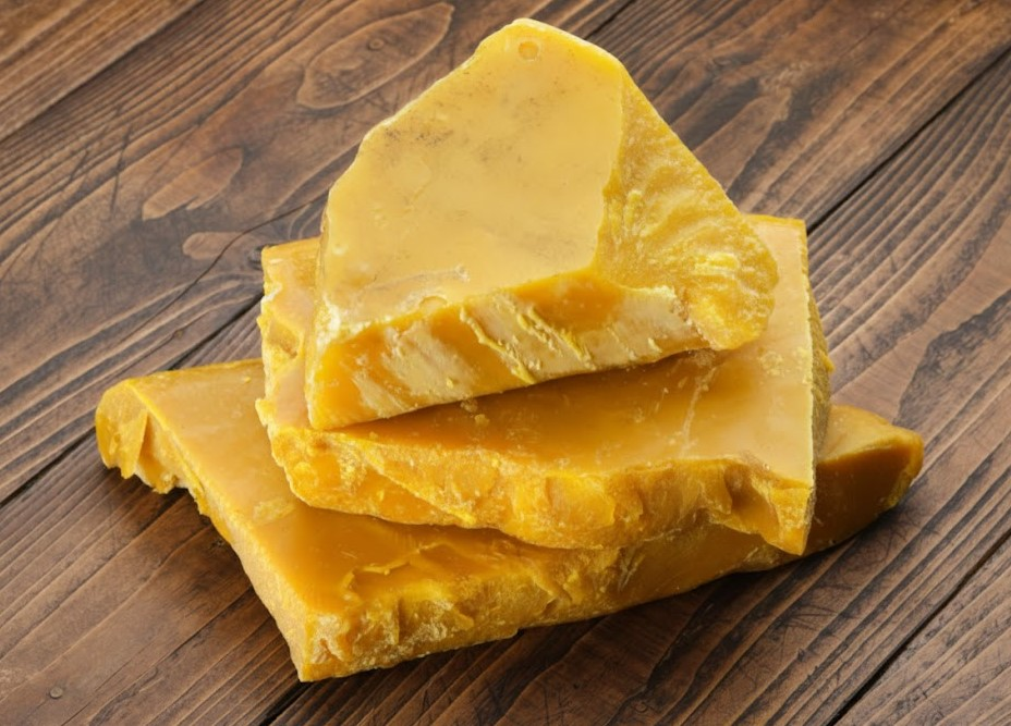 Pure yellow blocks of beeswax illustrating the natural benefits of beeswax for DIY products.